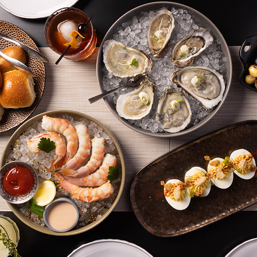 Image showing chef-inspired dishes on a table in Twin View Restaurant at Evermore Orlando Resort.