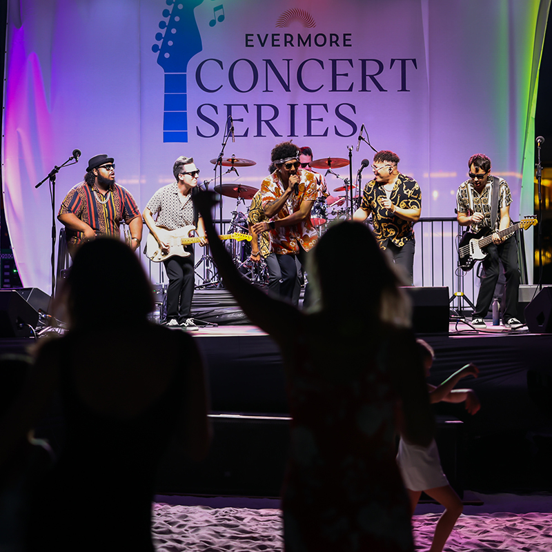 Image of guests dancing on the beach while enjoying live music during the Evermore Concert Series at Evermore Orlando Resort.