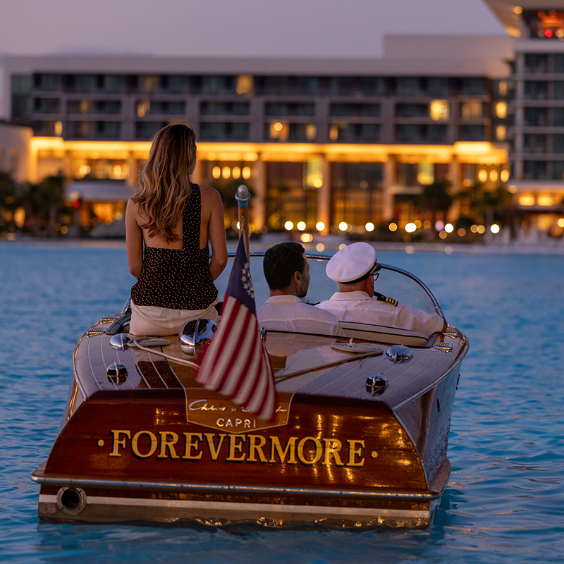 Image of a couple enjoying the Chris-Craft Cocktail Cruise experience on Evermore Bay at Evermore Orlando Resort.