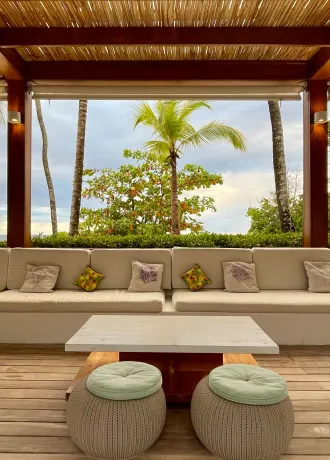 Cabana like lounge area overlooking palm tress