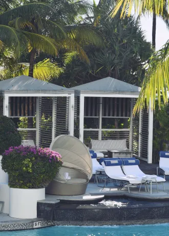 Pool Side Cabanas Cabanas and lounge chairs on edge of pool side