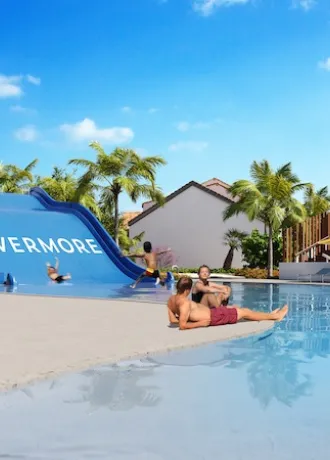 Rendering of Evermore waterslide with kids sliding down into the bay and people lounging on shores edge 