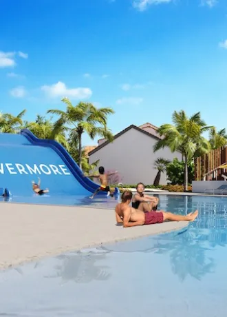 Evermore Waterslide Rendering of Evermore waterslide with kids sliding down into the bay and people lounging on shores edge