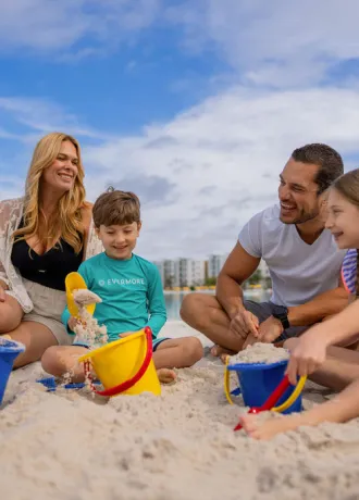 Family playing in the sand