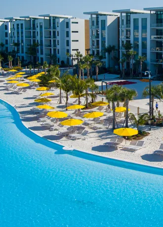 Image of the exterior of the 5-Story Tower Flats overlooking Evermore Bay at Evermore Orlando Resort.