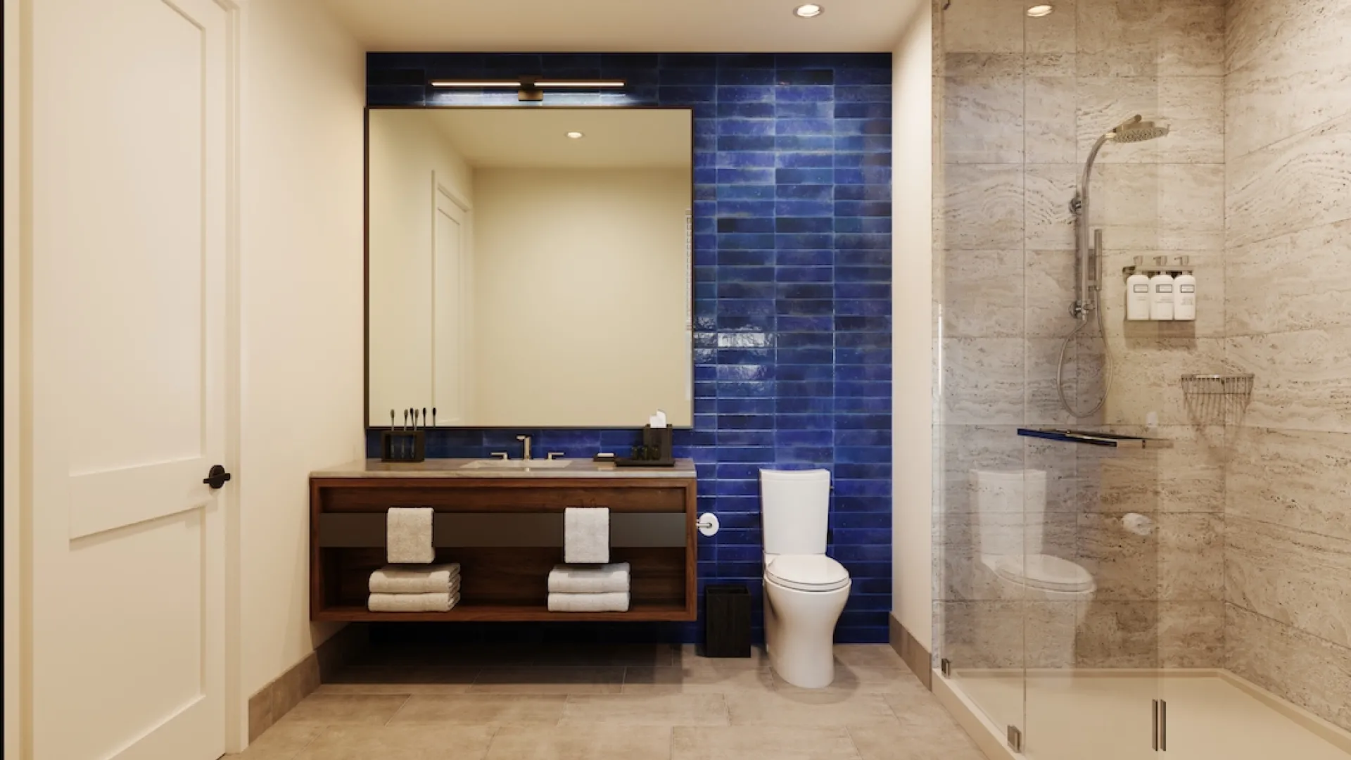 Interior shot of 11 bedroom guest bathroom with wooden vanity, blue marble backsplash, sliding glass shower doors