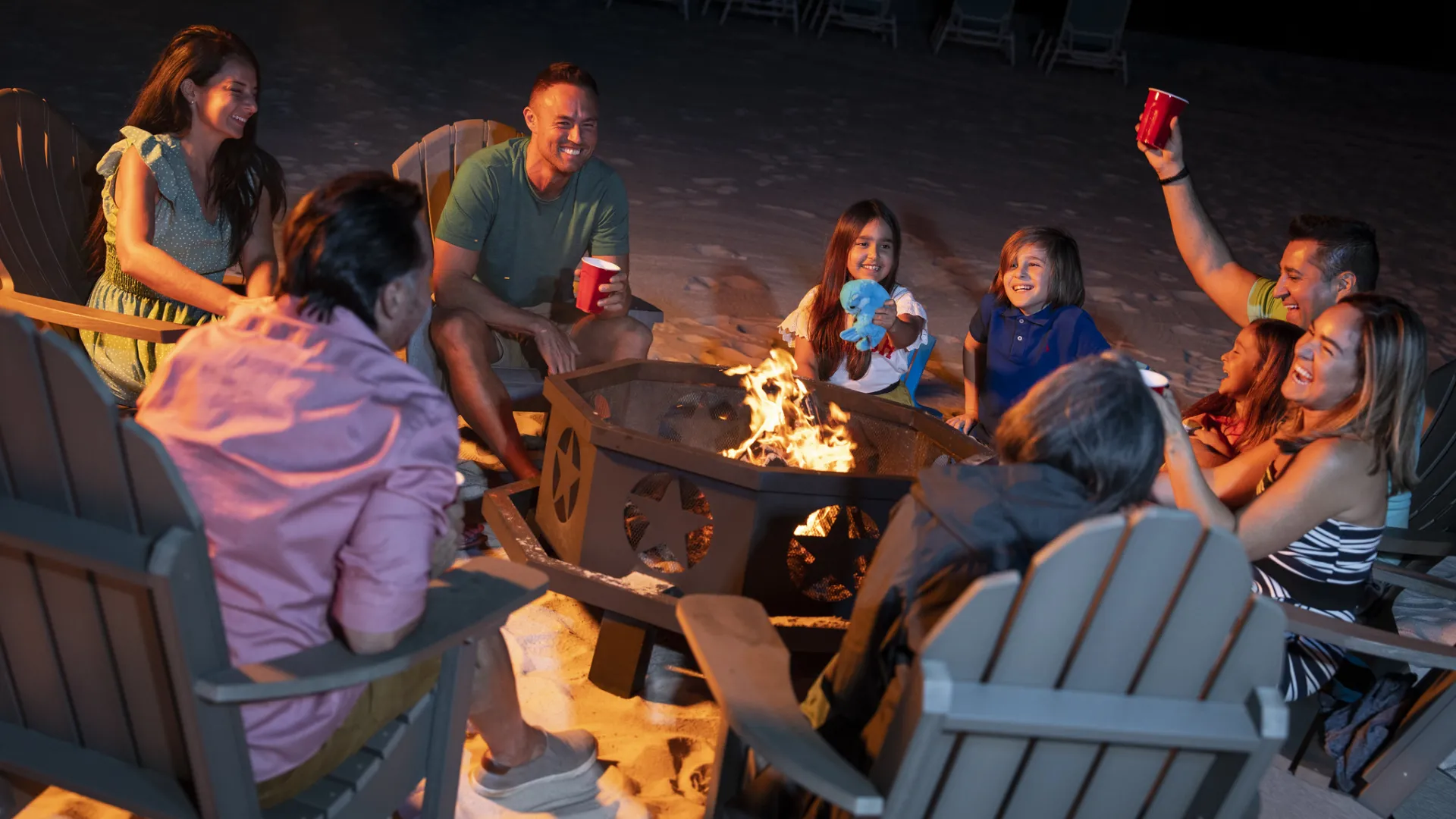 Family and Friends enjoying evening bonfire together 