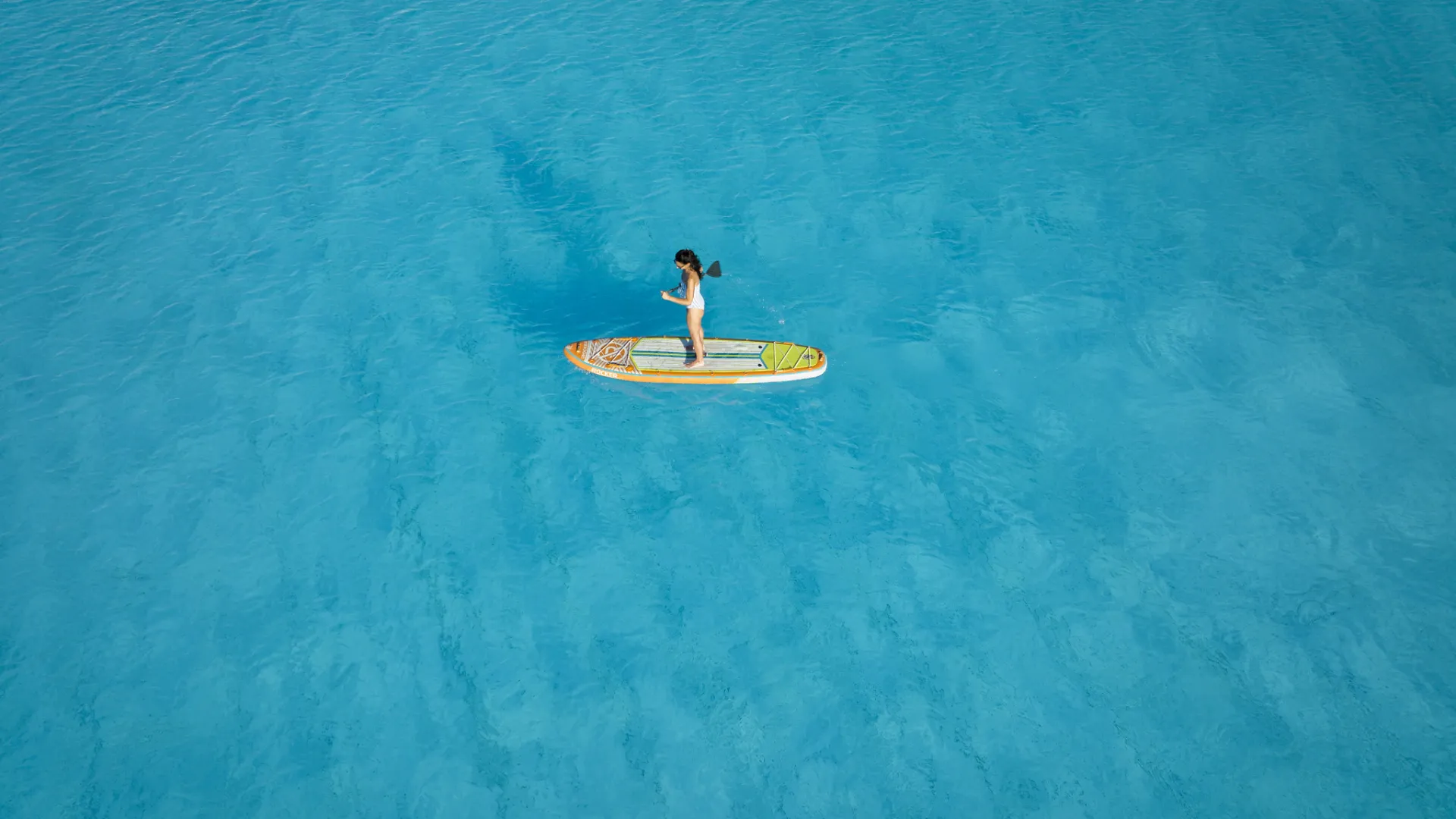 Overhead View of Guest Paddle Boarding Evermore Bay