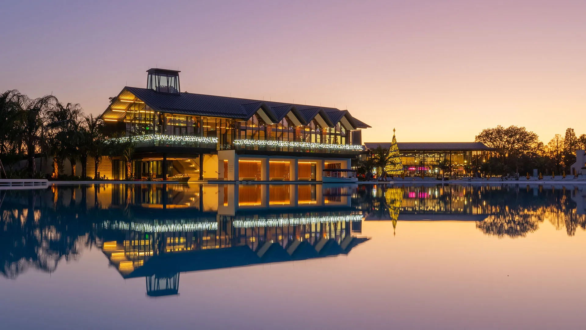 An image of the Boathouse and The Landing decorated for the holiday season at Evermore Orlando Resort.