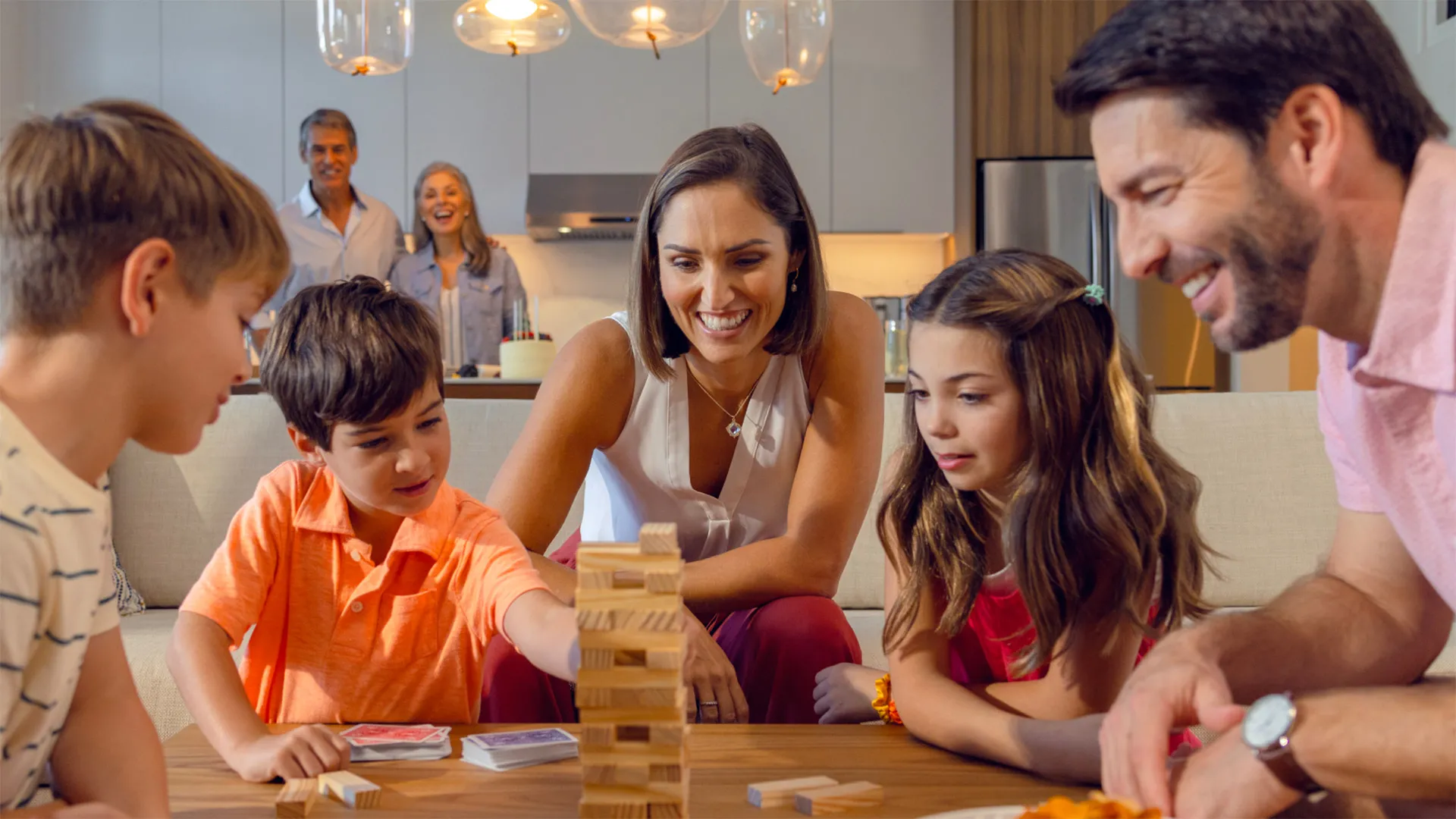 An image of a family playing games together in a Flat at Evermore Orlando Resort.