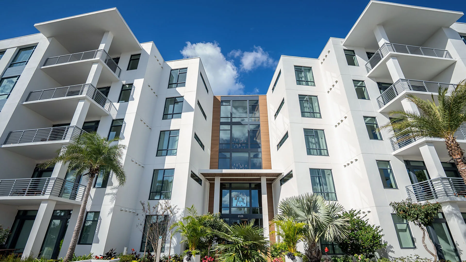 An image of the exterior of the 5-Story Tower Flats from the boardwalk at Evermore Orlando Resort.