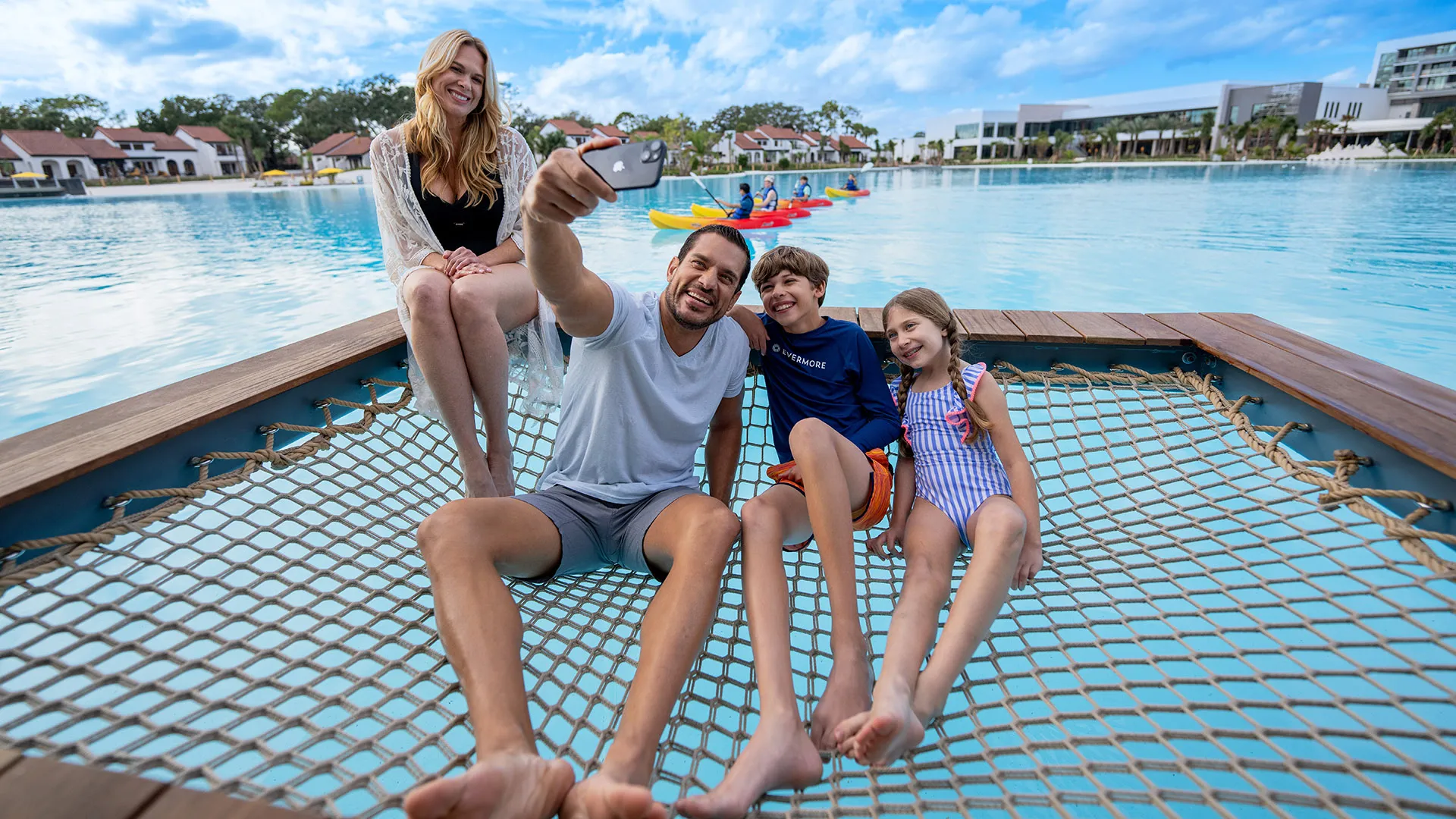 An image of a family taking a selfie in a private overwater cabana on Evermore Bay at Evermore Orlando Resort.