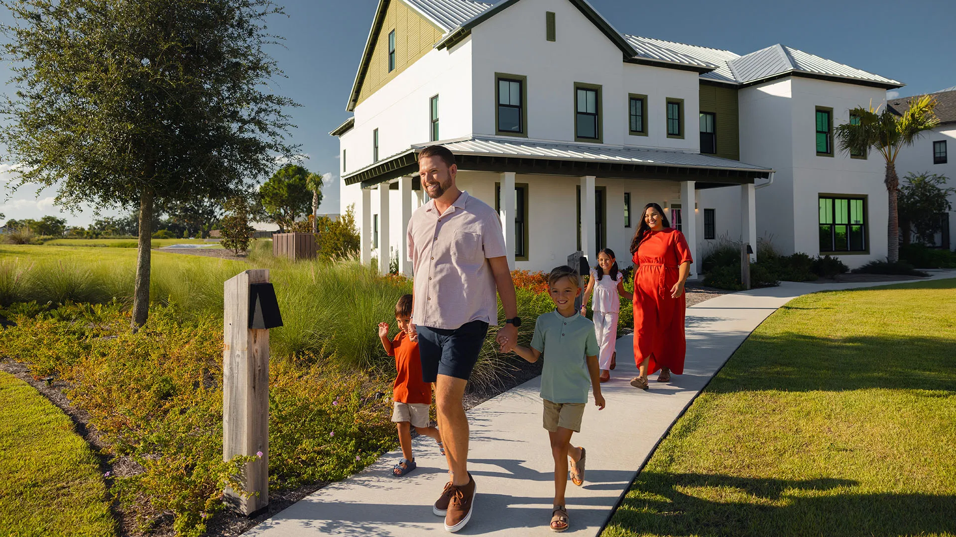 Family Walking from Their Evermore House Image of a family walking by their vacation home at Evermore Orlando Resort.