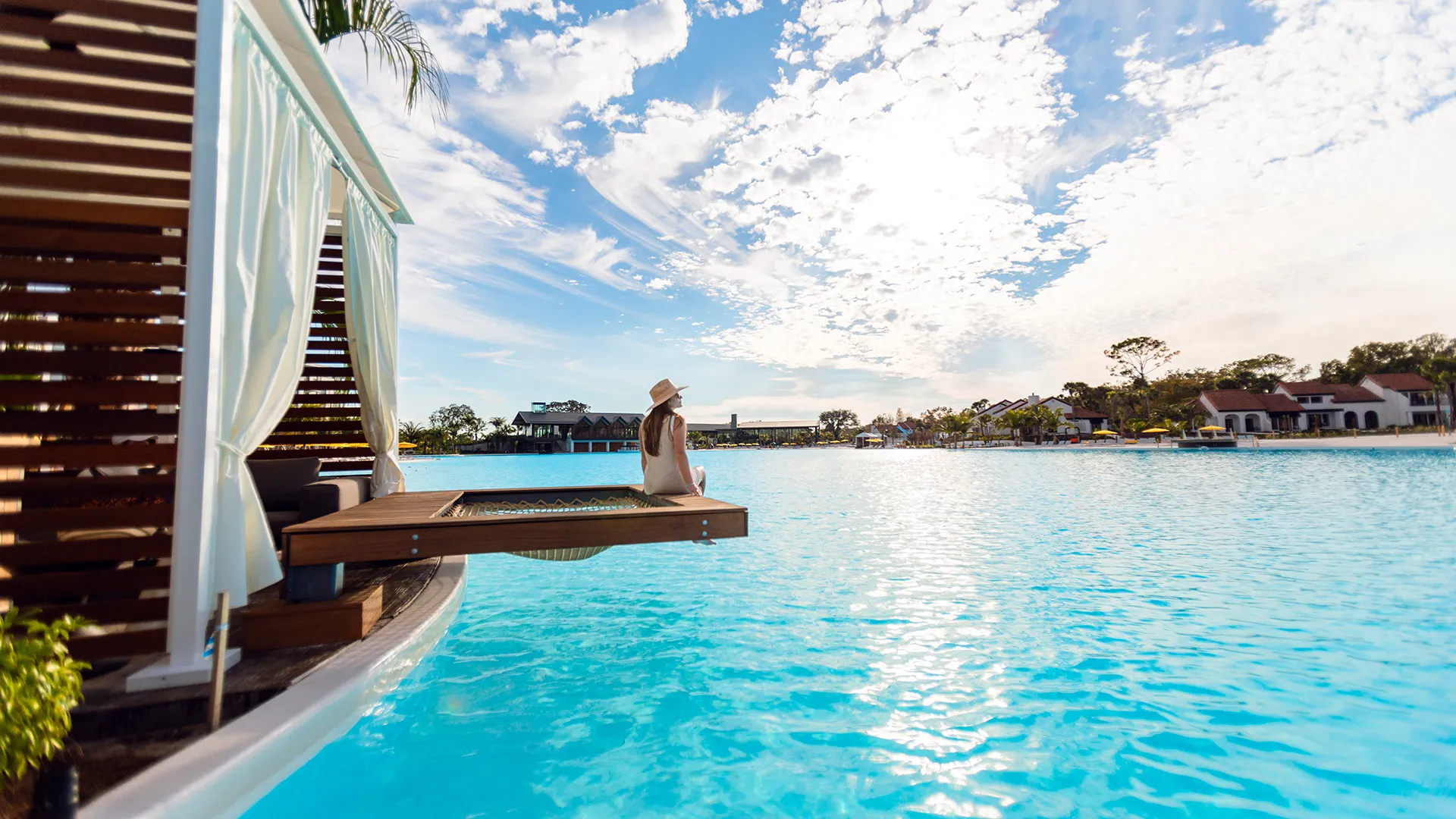 An image of a woman enjoying a Private Cabana in Evermore Bay.