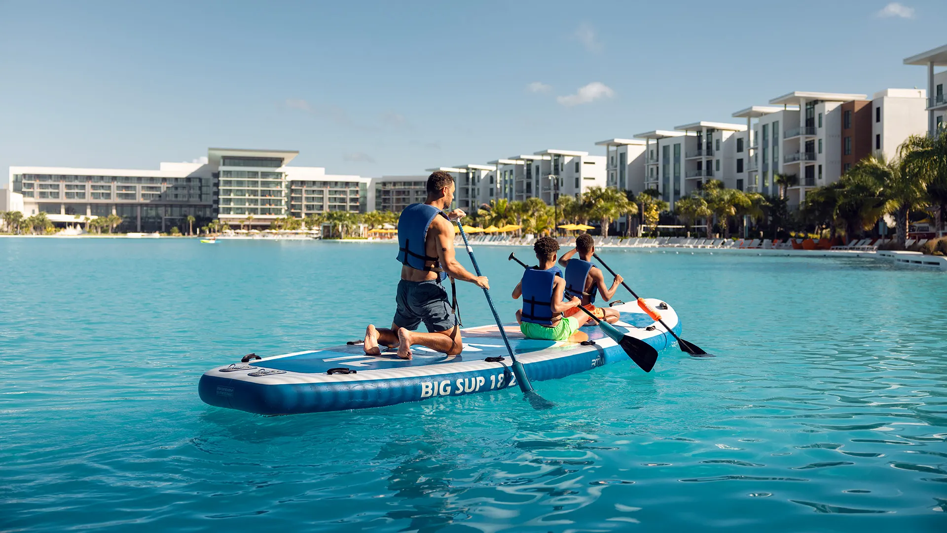 An image of guests on stand up paddleboard in Evermore Bay.