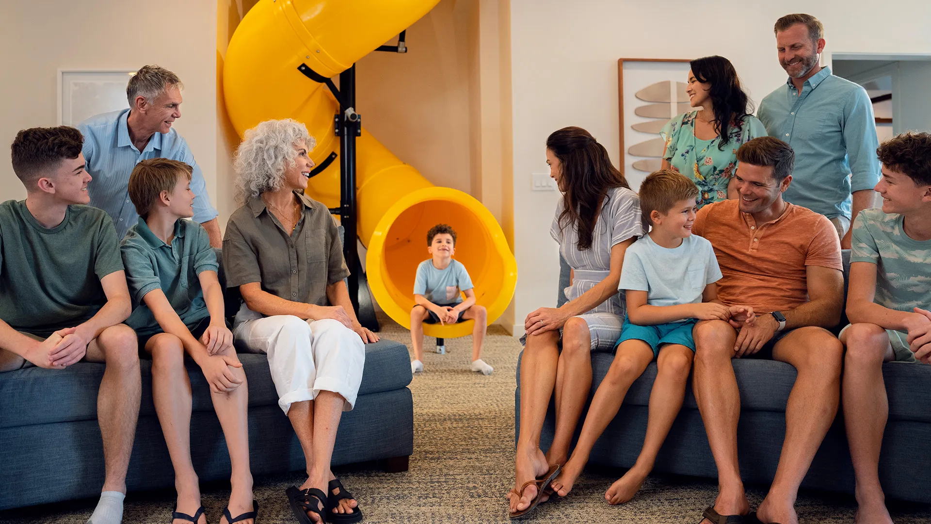 An image of a multi-generational family sitting in front of slide in an Evermore House.