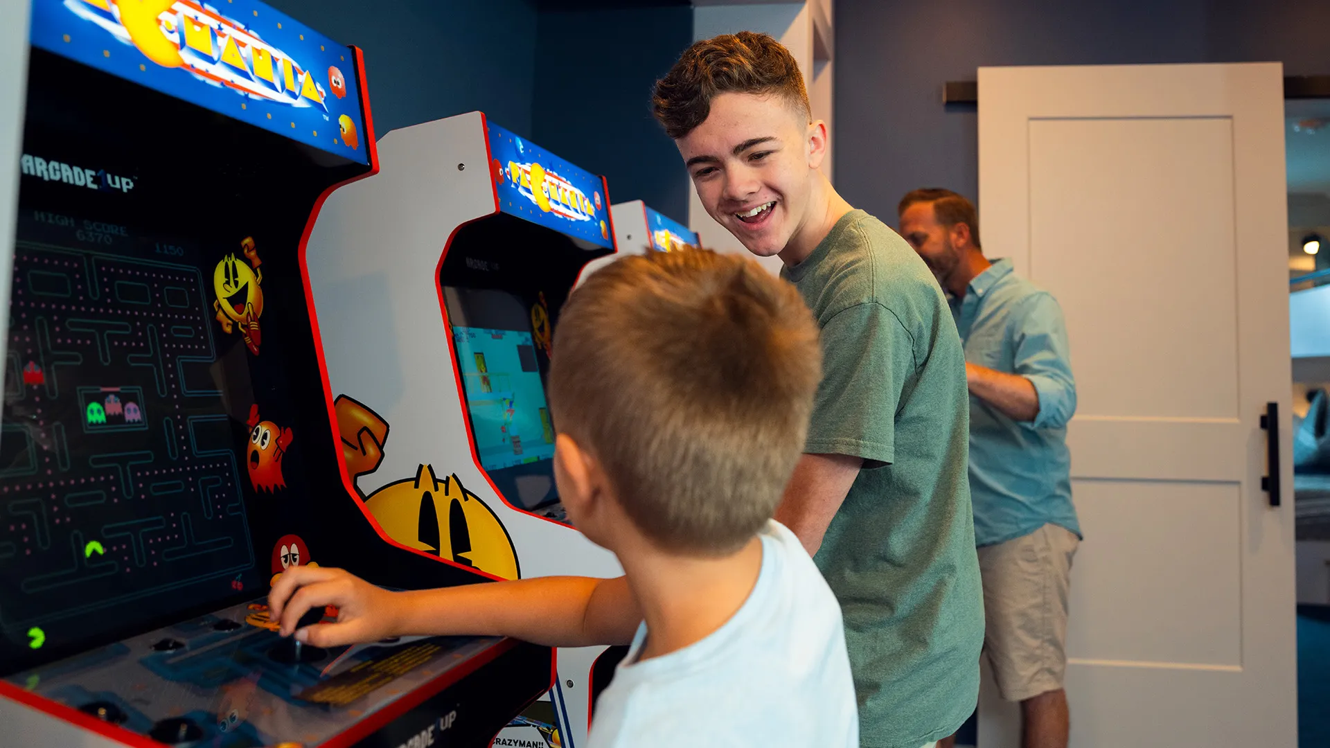 An image of children playing arcade games in an Evermore House.