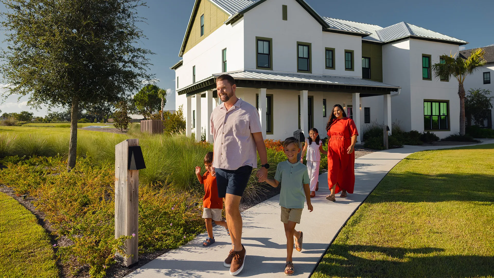 An image of a family in front of the exterior of an Evermore House.