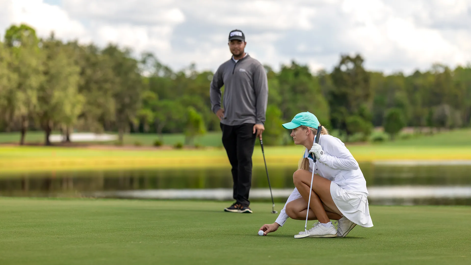 Image of a woman preparing for her putt during on the Grand Cypress Golf Cypress Course at Evermore Orlando Resort.