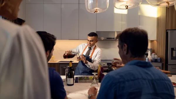 An image of a bartender making a craft cocktail inside a Flat at Evermore Orlando Resort.