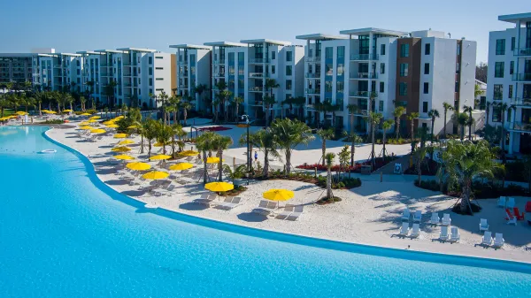 An image of the 5-Story Flats overlooking Evermore Bay at Evermore Orlando Resort.