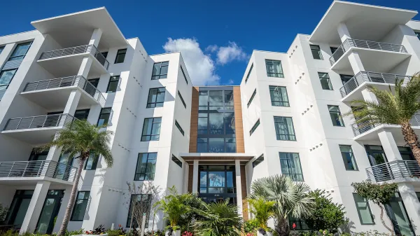 An image of the exterior of the 5-Story Tower Flats from the boardwalk at Evermore Orlando Resort.