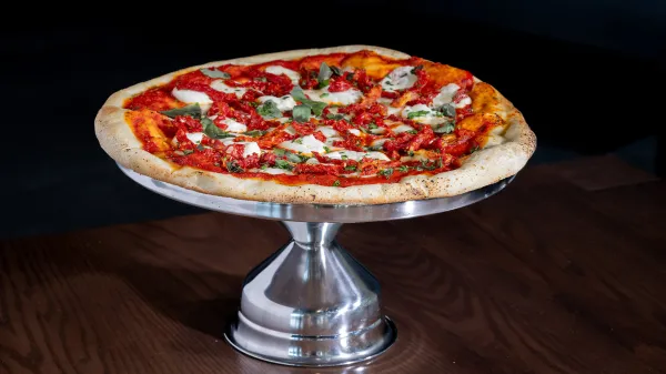 An image of a gourmet pizza delivered from Props Pizza at Evermore Orlando Resort.