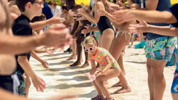 Image of guests participating in the Water Balloon Toss activity during Evermore Bay Games at Evermore Orlando Resort.