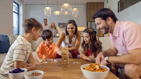 Image of a family playing games together in a Flat at Evermore Orlando Resort.