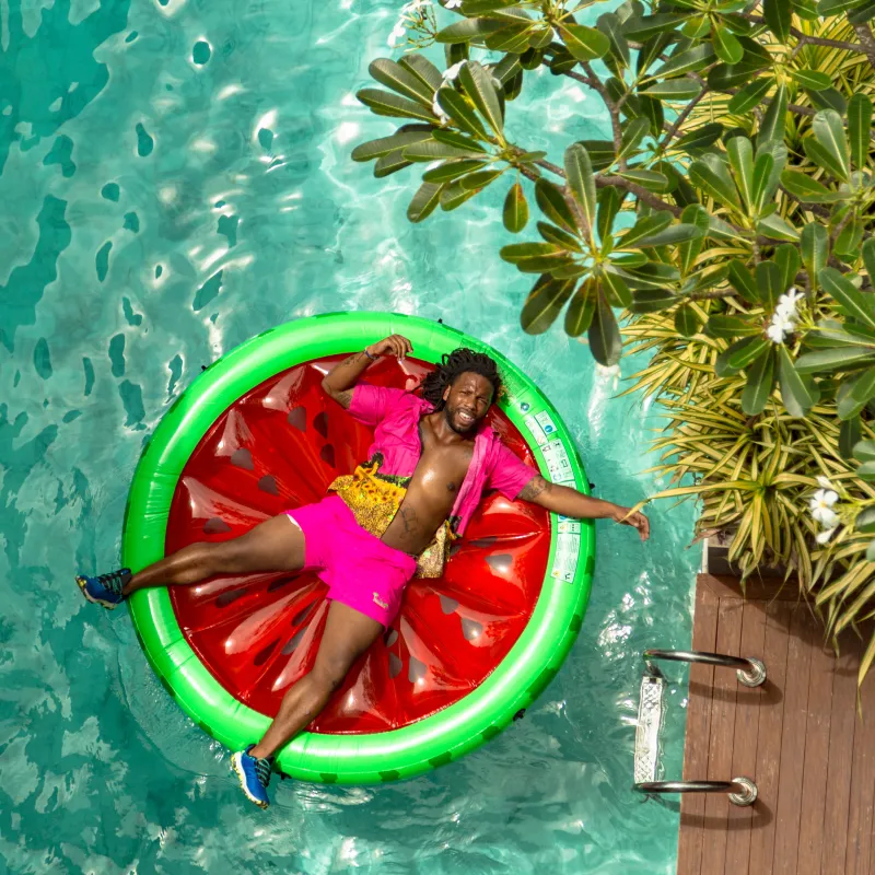 Guest floating on pool float that looks like a watermelon 