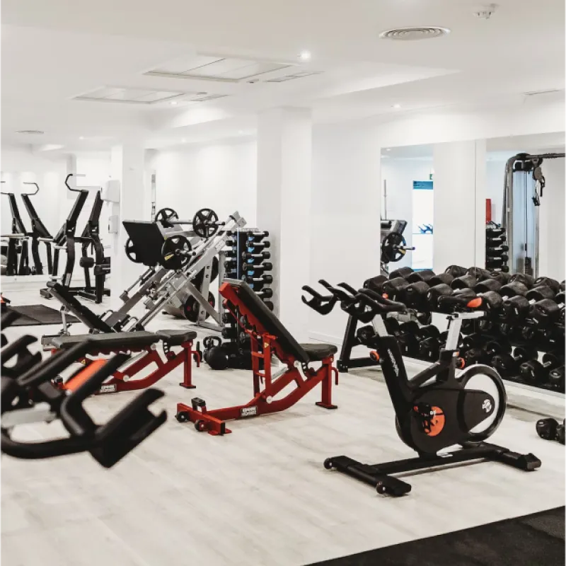 Interior image of gym with weights, and work out equipment