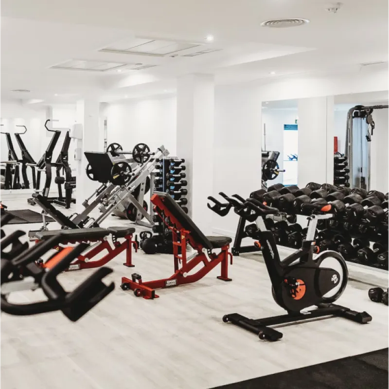 Gym with Equipment Interior image of gym with weights, and work out equipment