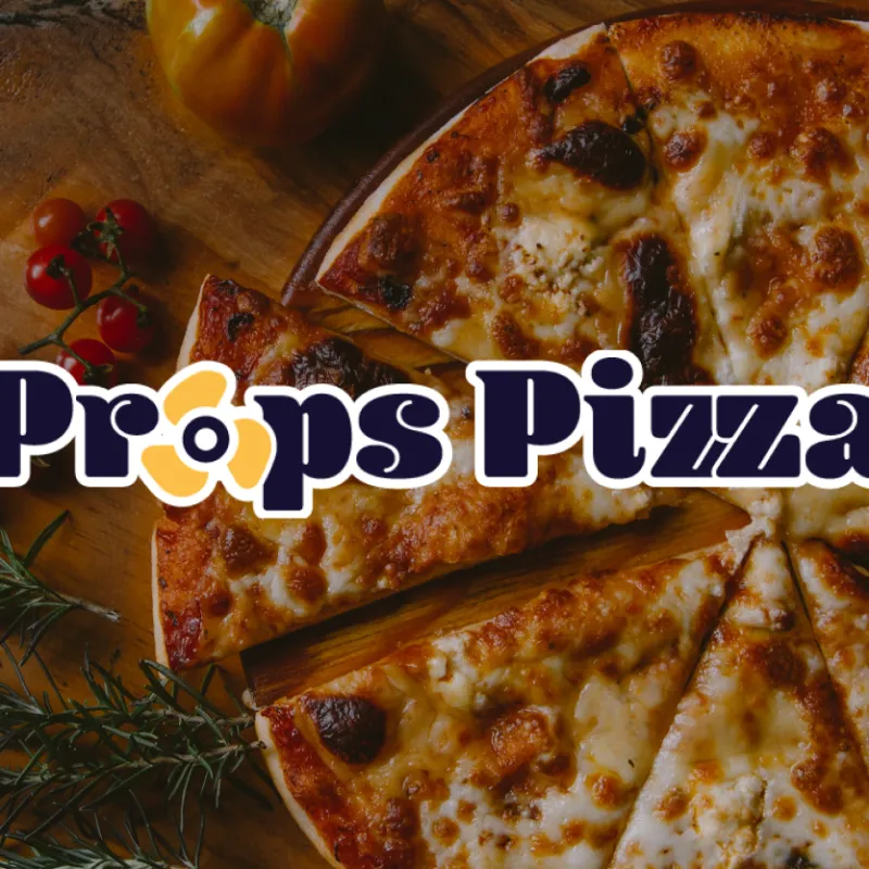 Props Pizza Props Pizza logo placed over image of fresh pizza on cutting board with tomato and thyme