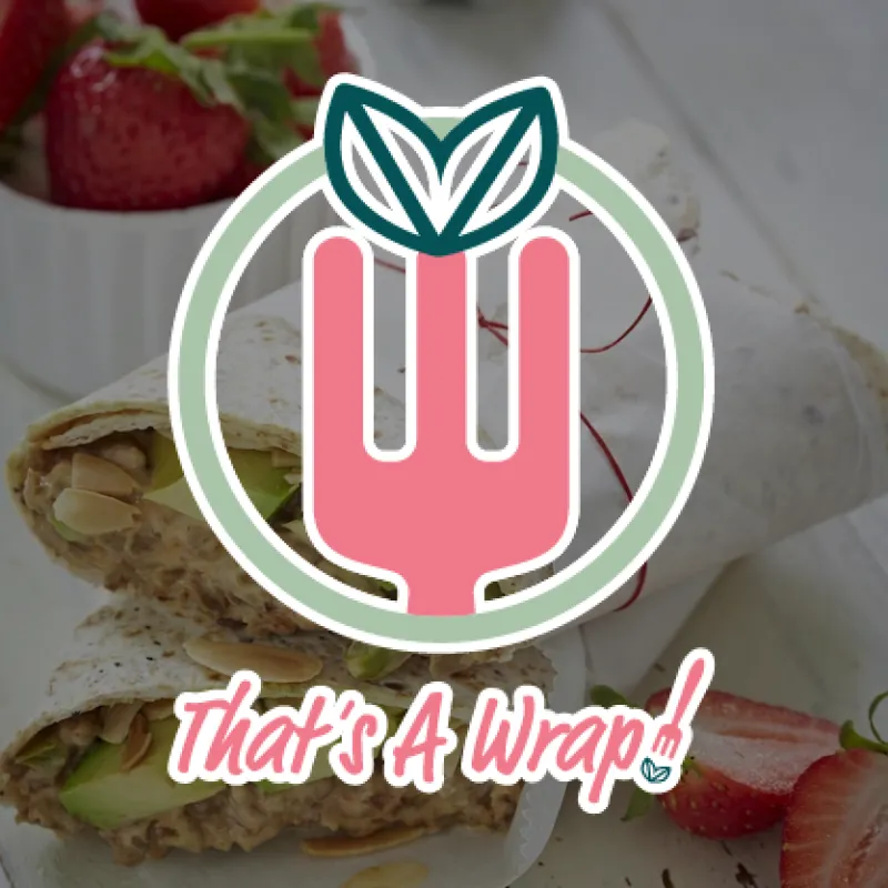 That's a Wrap logo overlayed on image of wrap cut in half and cup of strawberries