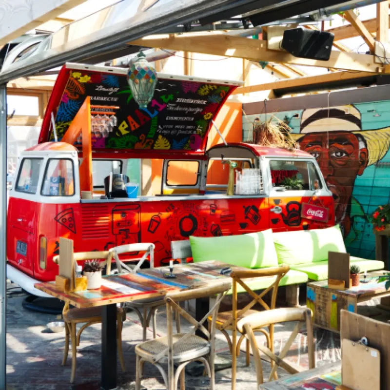 Taqueria Food Truck Exterior shot of Taqueria Food Truck with dining tables close by