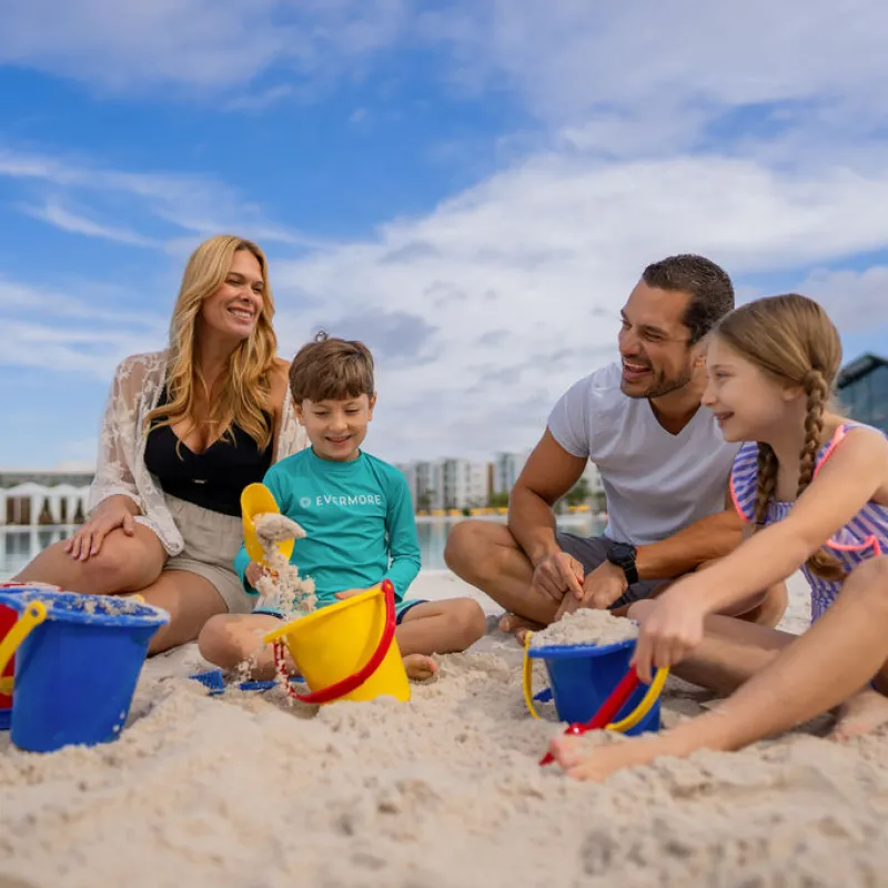 Family playing in the sand