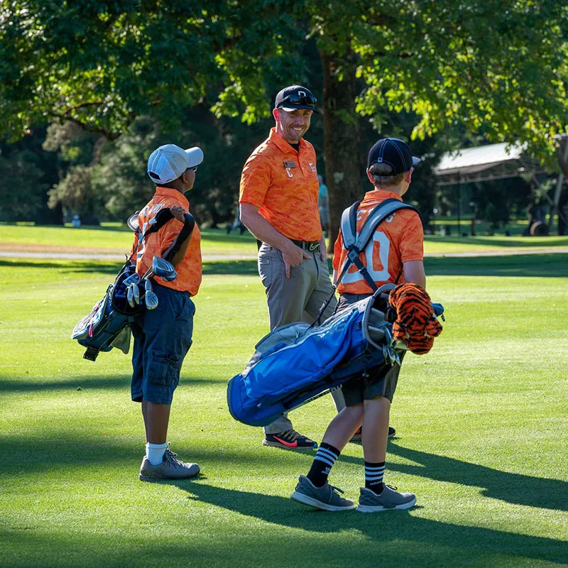 An image of a PGA instructor teaching children about on course play during a Grand Cypress Golf summer camp at Evermore Orlando Resort.