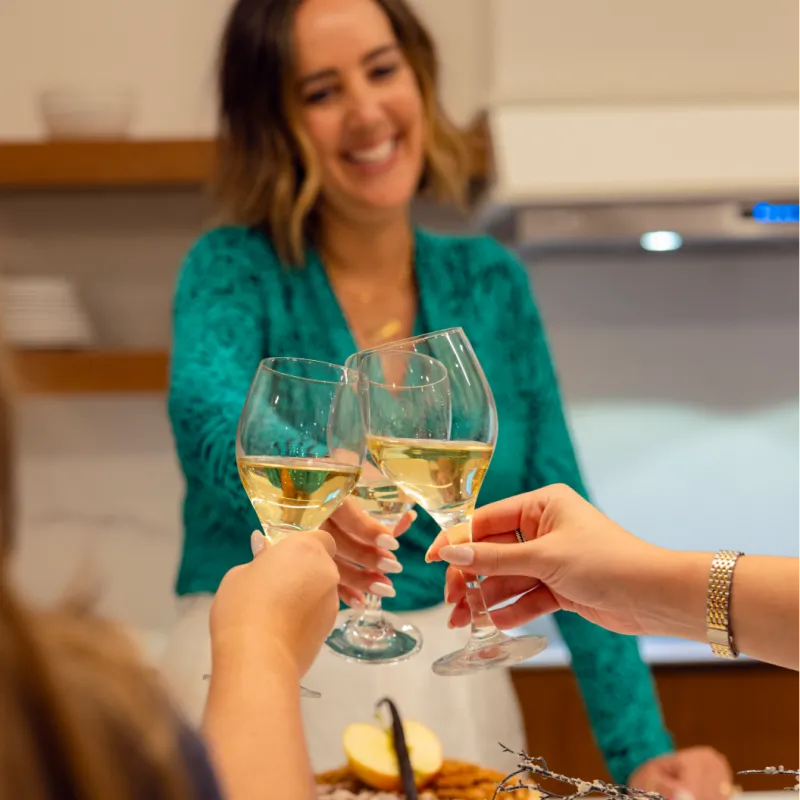 Family cheers'ing around Holiday Dinner