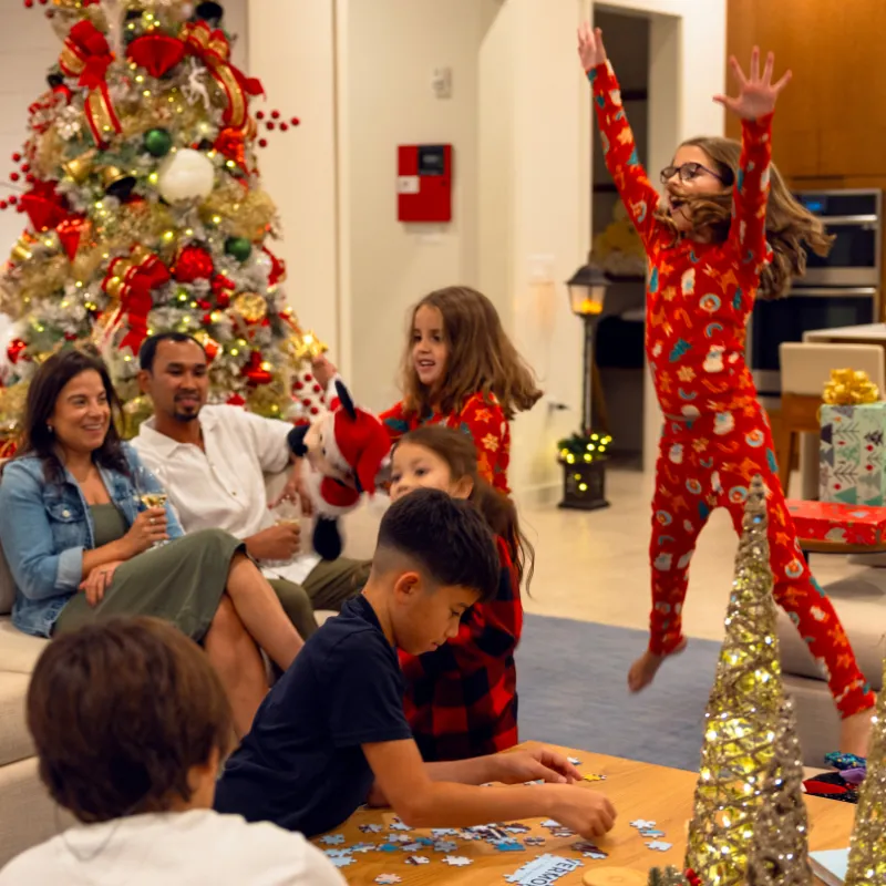 Image of a family enjoying quality time together in their vacation home with holiday decorations at Evermore Orlando Resort.