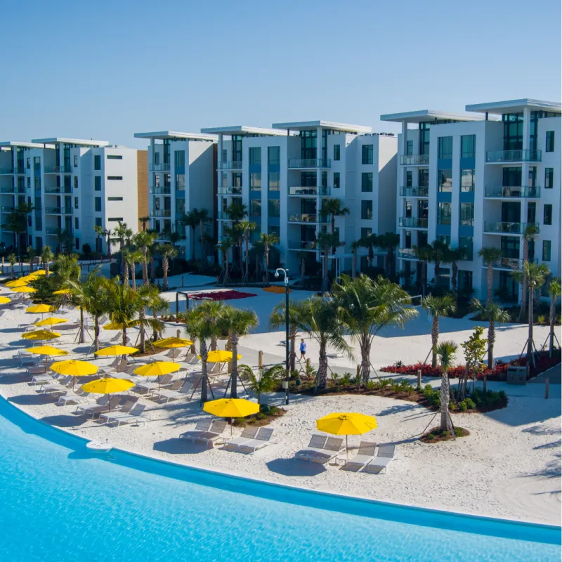 Aerial image of the 5-Story Tower Flats with a view of Evermore Bay at Evermore Orlando Resort.