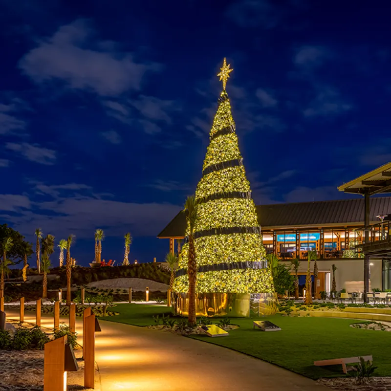 Image of The Landing Lawn decorated for the holidays at Evermore Orlando Resort.