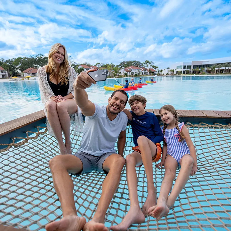Image of a family taking a selfie in a private overwater cabana on Evermore Bay at Evermore Orlando Resort.