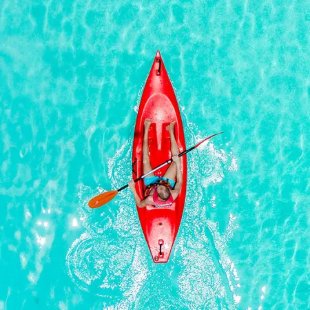 Overhead image of guest kayaking in Evermore Bay