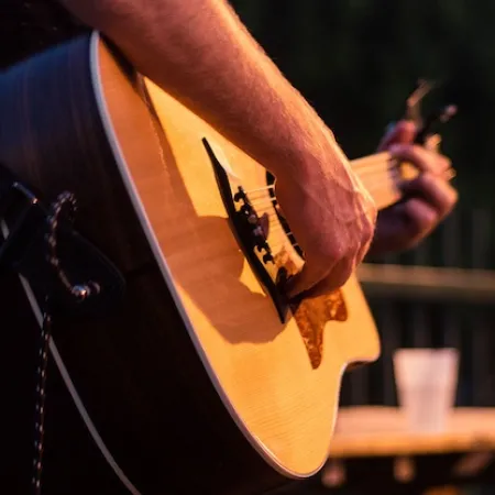 Close up of musician strumming guitar 