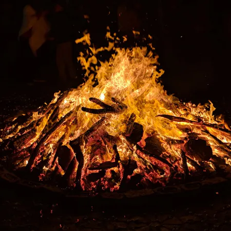 Close of image of blazing fire in a firepit at nighttime 