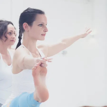 An image of two women participating in a ballet fitness class.
