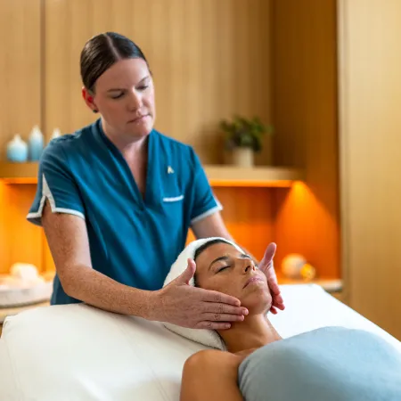 An image of a woman enjoying a facial treatment in the Conrad Spa Orlando.