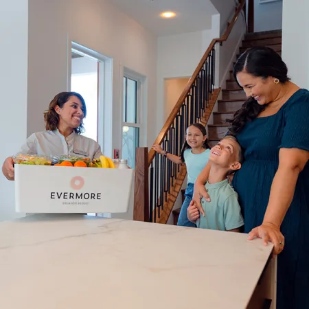 Evermore To Your Door Grocery Delivery Image of an Evermore team member delivering an Evermore To Your Door grocery delivery to a private vacation House at Evermore Orlando Resort.