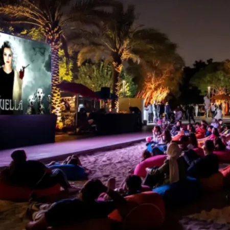 Image of guests enjoying Spooky Movies on the beach at Evermore Orlando Resort.