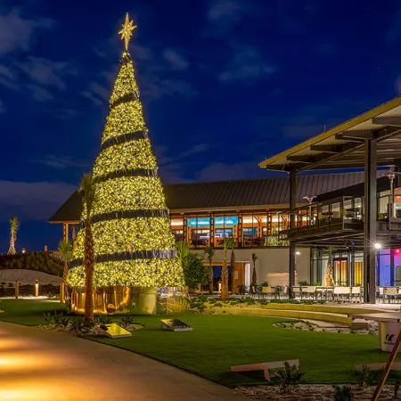 Image of The Landing Lawn decorated for the holidays at Evermore Orlando Resort.